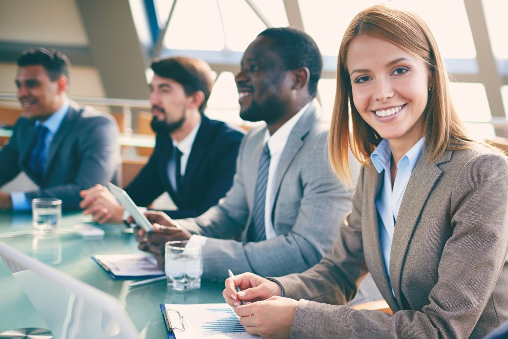 people smiling at a meeting